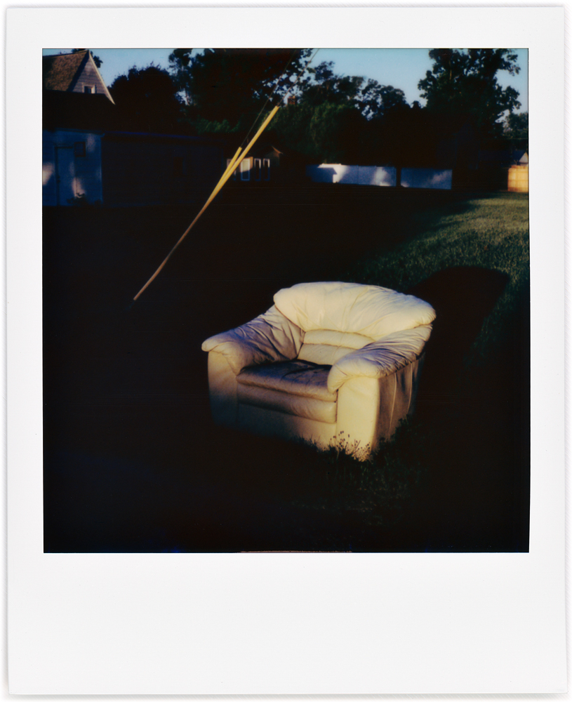 Polaroid photo of a chair left out for the trash in my neighborhood.